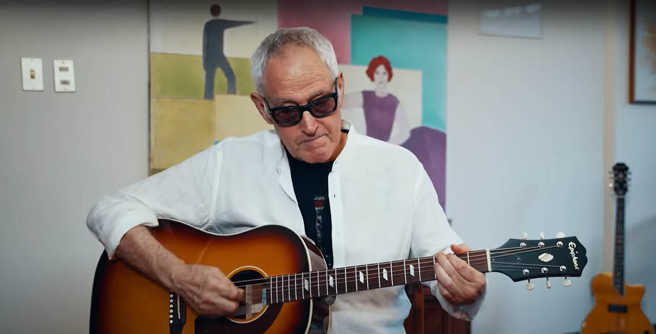 Jordano with an Epiphone Texan acoustic guitar